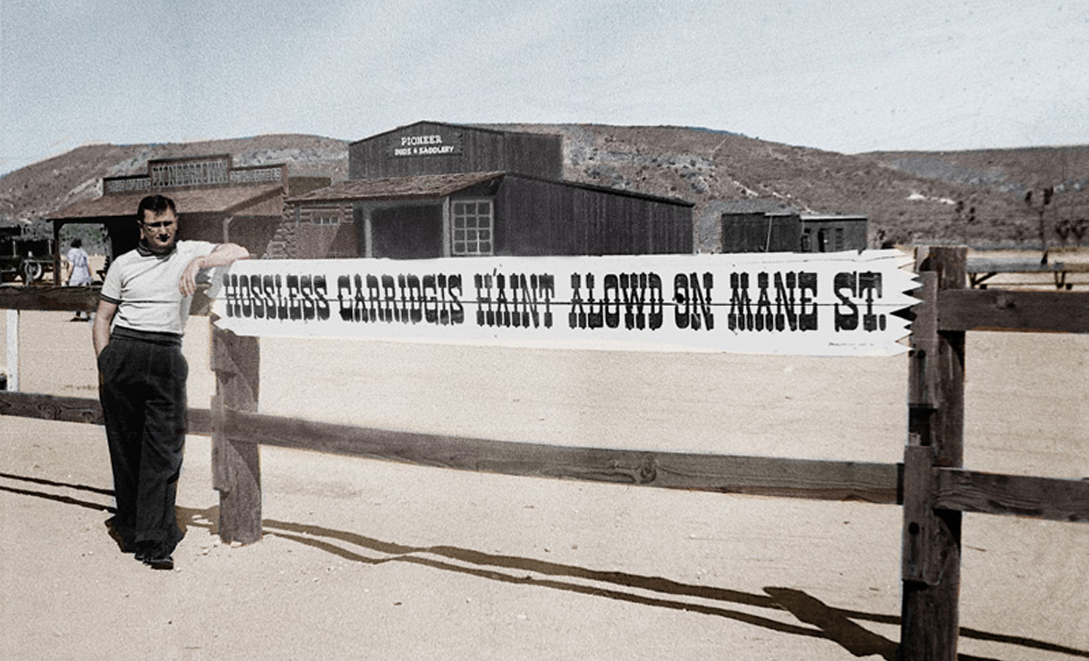 man in front of mane street sign